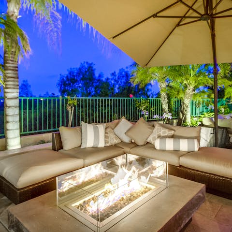 Wind down around the outdoor glass-cased fire pit