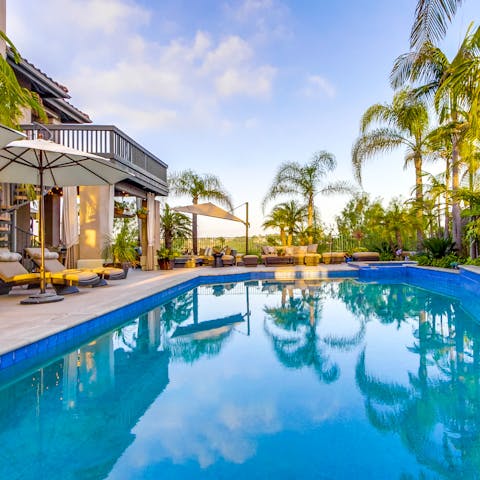 Cool off in the impeccable palm-lined swimming pool