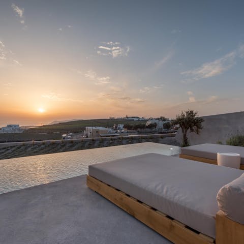 Sprawl out on a lounger and take in the famous Santorini sunset