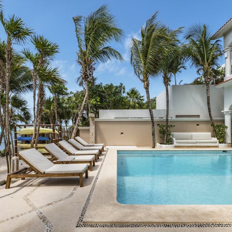 Choose to relax by the stunning pool, enjoying the breeze coming from the ocean