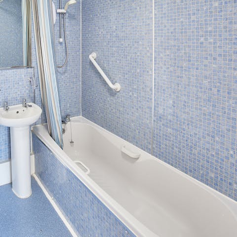 Indulge yourself with long and leisurely soak in the blue bathtub