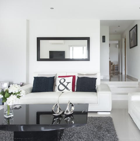 Relax and cool off in the sleek, monochrome living space