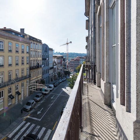 Step out onto your private balcony and watch people bustle along the pavement below