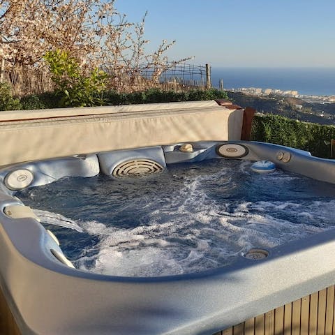 Unwind in the jacuzzi after serving spicy gazpacho at the dining table