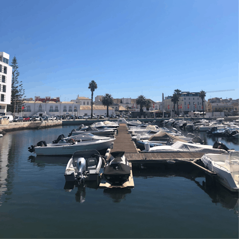 Watch the boats coming in and out of bustling Faro Marina