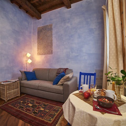 Unwind in the charming timber-beamed living space with original fresco walls