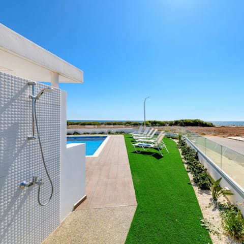 Enjoy a refreshing outdoor shower while soaking in the sea views