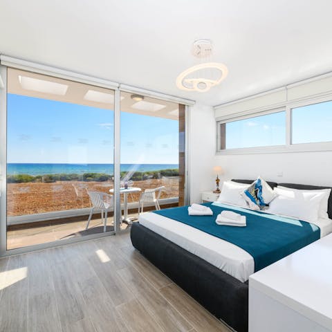 Gaze out at ocean views from your bed through the floor-to-ceiling windows