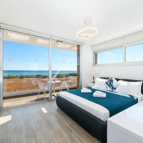 Gaze out at ocean views from your bed through the floor-to-ceiling windows