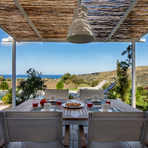 Catch glimpses of the shimmering sea while dining alfresco beneath the pergola