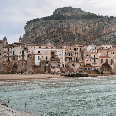 Visit the coastal city of Cefalù, known for its Norman cathedral and sandy beaches
