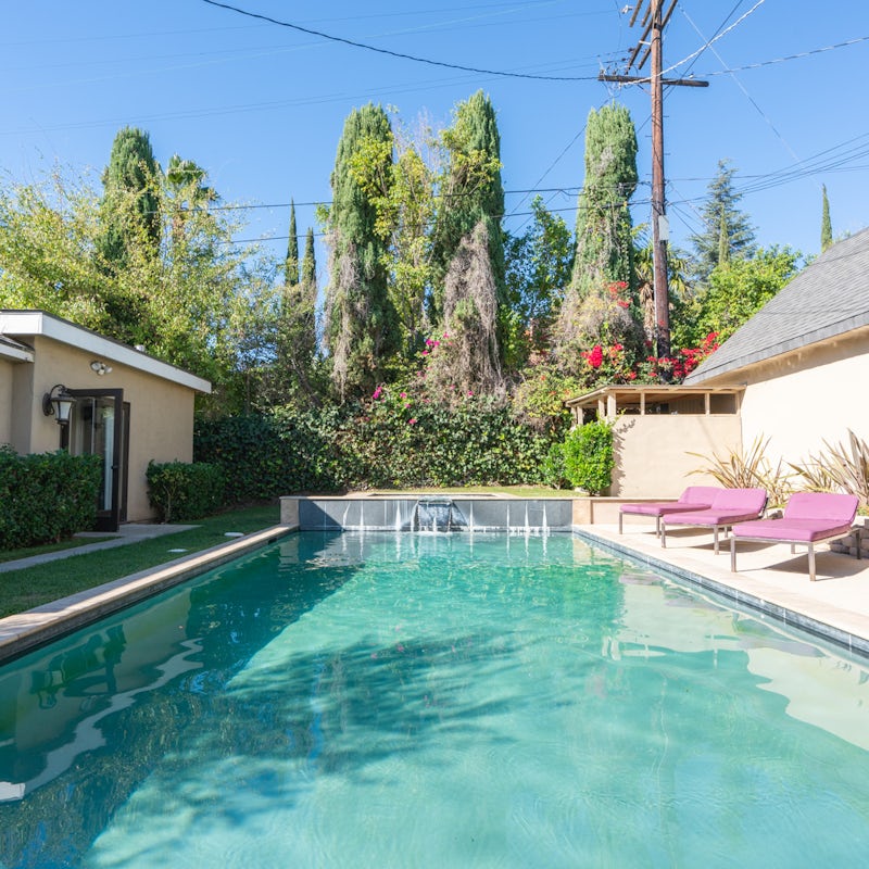 Take the plunge in your aquamarine pool with waterfall fountains