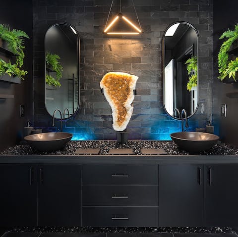 Preen and pamper yourself in the monolithic black bathroom – the beautiful quartz crystal is said to amplify energy