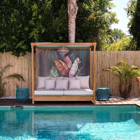 Spend lazy days lounging on the daybed by the pool