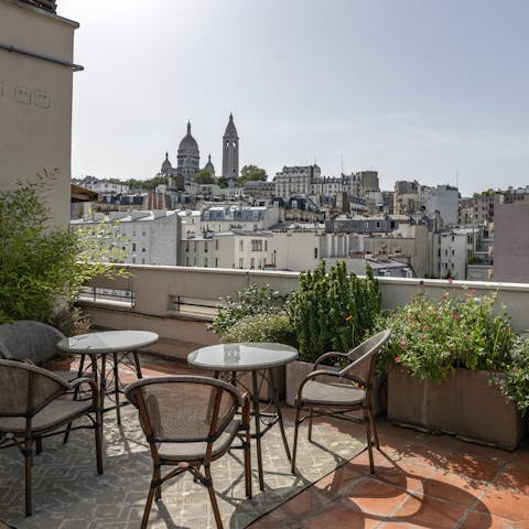 Admire the sweeping Sacré-Cœur views, a glass of wine in hand