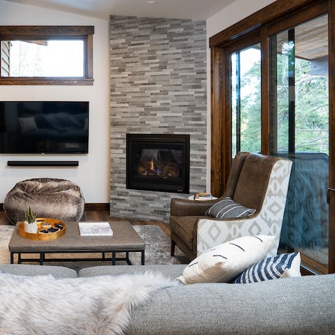 Relax on the comfy cushions by the fireplace after a day of outdoor activities