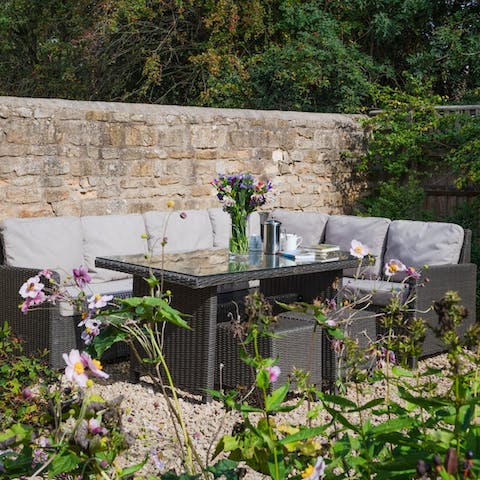 Enjoy alfresco meals in amid the flowers of the courtyard garden