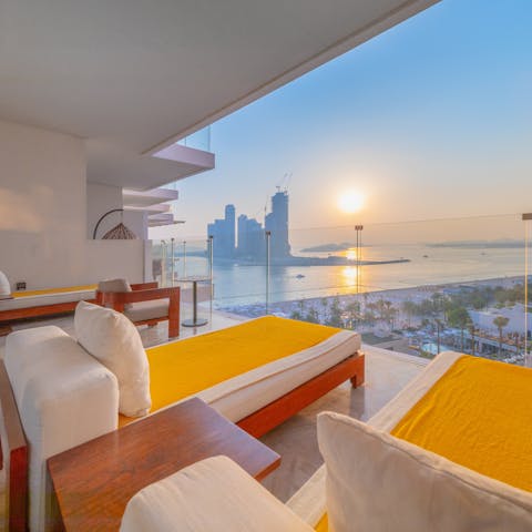 Watch the sun set over the Persian Gulf from the balcony