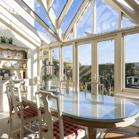 Enjoy group meals in the luminous conservatory