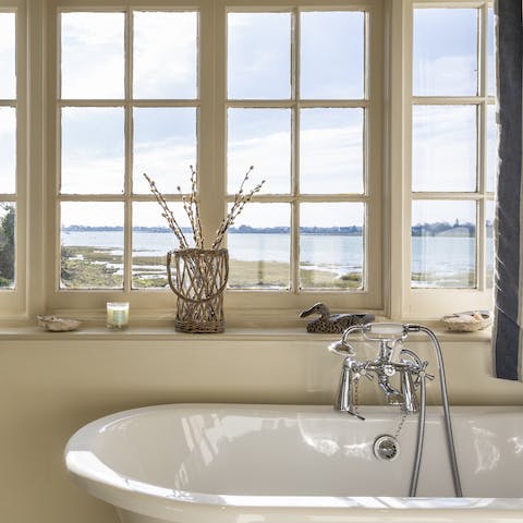 Relax in the roll-top bathtub with a view