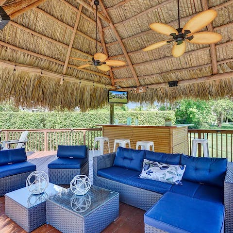 Kick back with a cocktail in the tiki bar by the pool