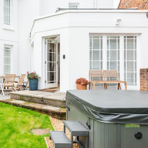 Watch the sun go down from the comfort of the hot tub in the garden