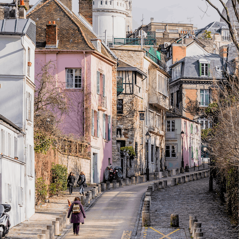 Hike up the cobbled passages of colourful Montmartre, four minutes away