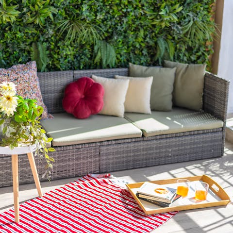 Nestle into the outdoor sofa and read in the southern sunshine