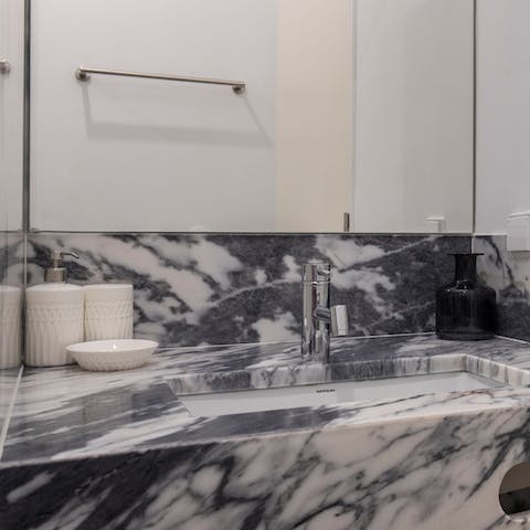 Get ready for a night out in Lisbon in the marble bathroom
