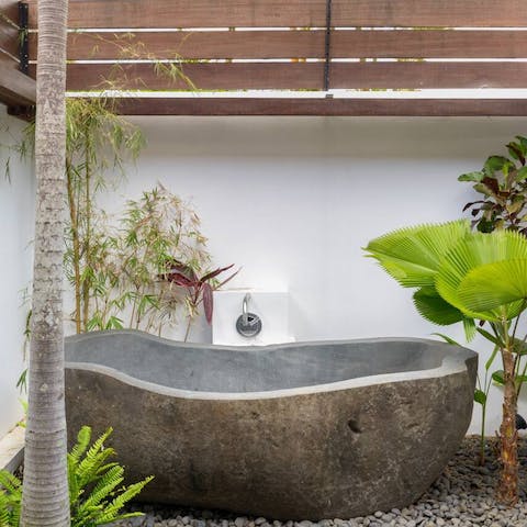 Have a relaxing soak in the solid stone outdoor bathtub