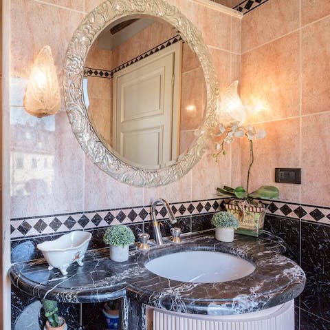 Freshen up at the luxurious,  solid marble sink the bathroom