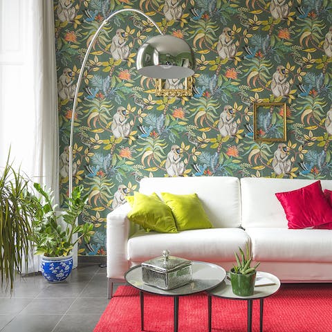 Admire the quirky jungle-printed wallpaper in the living room