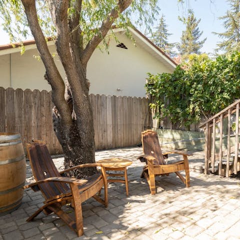 Pour a glass of local wine and find a quiet spot to relax under the trees  