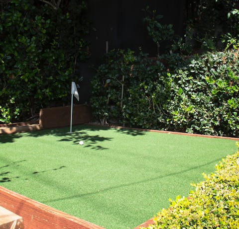 Hone your putting on the mini green at the side of the home