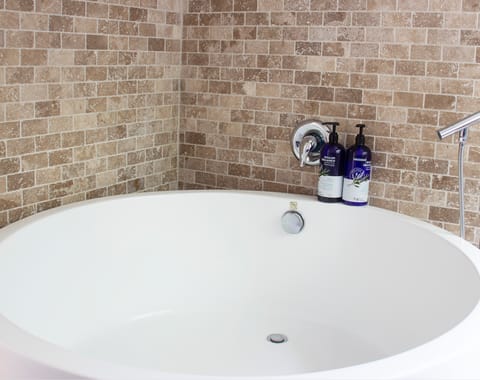 Treat yourself to a long soak in the round bathtub at the end of the day