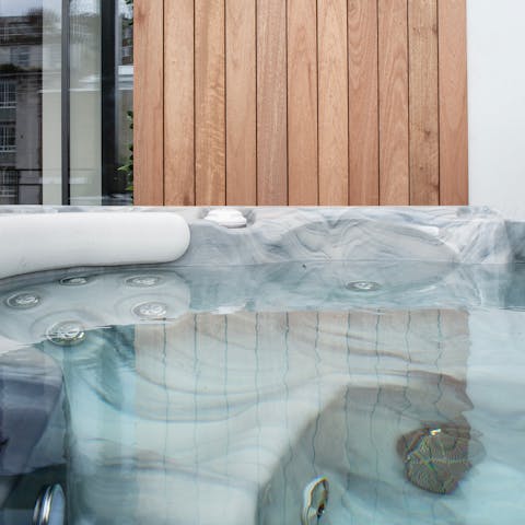 Enjoy a soak in the private hot tub after a meeting in the sitting area