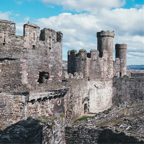 Explore the famous fortress of Conwy Castle, just three miles away from here