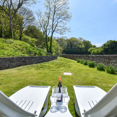 Sunbathe on your private lawn amid this ten-acre estate of gorgeous greenery