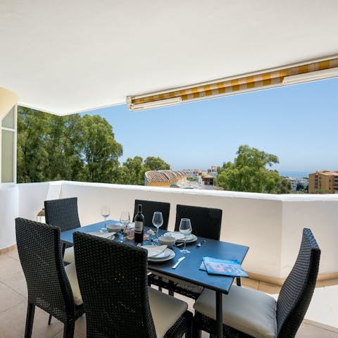 Enjoy an alfresco meal on the private balcony, with distant sea views