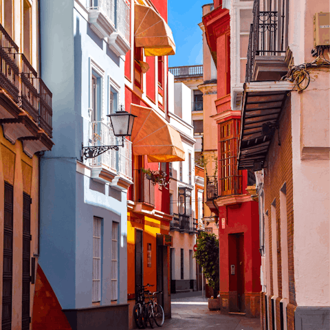 Wander through Seville's colourful streets before sitting down to tapas for lunch