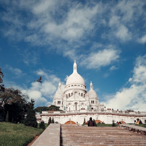 Climb the steps up to La basilique du Sacré-Cœur