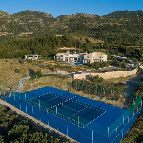 Plan an evening tennis match on the private asphalt court with floodlights