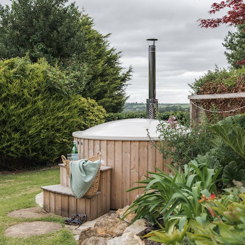 Heat up the wood-fired hot tub and admire the fields
