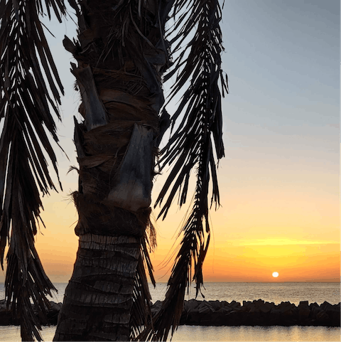 Go for a sunset stroll along Playa Flamingo, a twenty-minute walk or three-minute ride away
