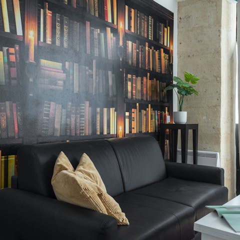 Kick back on the leather sofa and relax in front of the bookstore-inspired wallpaper