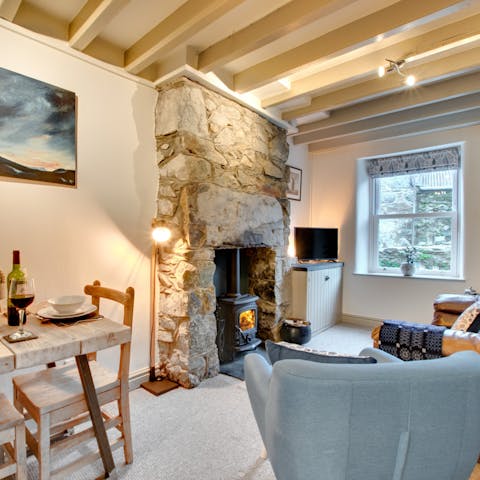 Cosy up in front of the log burner as you admire this exposed stone chimney breast
