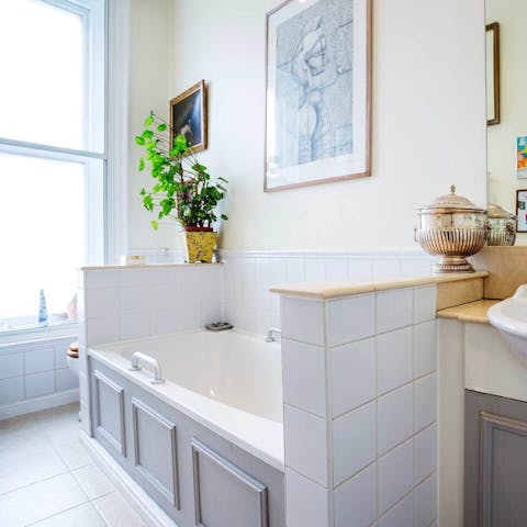 Relax with a long soak in the master bathroom's tub after a day of exploring the city