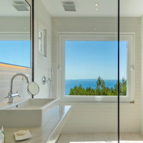 Refresh yourself under the shower with breathtaking sea views through the large window