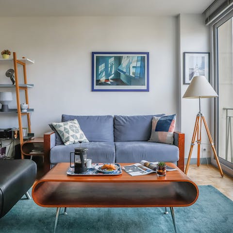 Kick back on the stylish mid-century modern sofa with a glass of French wine after a day of Paris sightseeing