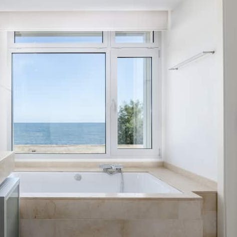 Soak in the tub at sunset as you gaze out to sea views